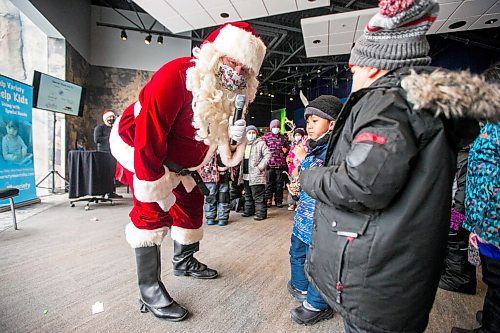 MIKAELA MACKENZIE / WINNIPEG FREE PRESS

Santa asks grade one/two Lavallee School student Lykan what he wants for Christmas at a Winter Wonderland party organized by Variety for kids from low-income schools at the Assiniboine Park Zoo in Winnipeg on Monday, Nov. 22, 2021. For Doug Speirs story.
Winnipeg Free Press 2021.