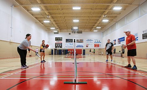 JOHN WOODS / WINNIPEG FREE PRESS
Winnipeg Free Press reporter Jen Zoratti, left, learns how to play pickleball with, from left, Rose Sawatzky, left, president of Pickleball Manitoba and National Championship silver medalist, Damien Rondeau, national 35+ 4.0 category champion, and Kevin Harrison, president of Winnipeg West Pickleball, at Sturgeon Heights Community Centre  on Tuesday, November 23, 2021. 

Re: zoratti