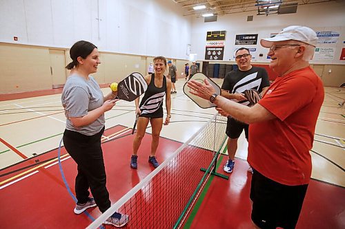 JOHN WOODS / WINNIPEG FREE PRESS
Winnipeg Free Press reporter Jen Zoratti, left, comes together after ta pickle ball game to pat paddles with Rose Sawatzky, left, president of Pickleball Manitoba and National Championship silver medalist, Damien Rondeau, national 35+ 4.0 category champion, and Kevin Harrison, president of Winnipeg West Pickleball, at Sturgeon Heights Community Centre  on Tuesday, November 23, 2021. 

Re: zoratti