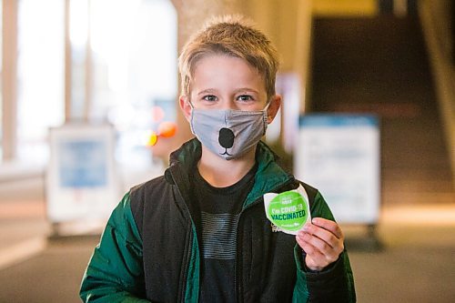 MIKAELA MACKENZIE / WINNIPEG FREE PRESS

Hayden Brown (eight) poses for a portrait in front of the RBC Convention Centre vaccination supersite after getting vaccinated in Winnipeg on Wednesday, Nov. 24, 2021. For --- story.
Winnipeg Free Press 2021.