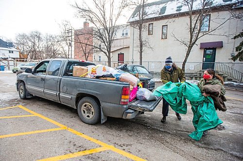 MIKAELA MACKENZIE / WINNIPEG FREE PRESS

Garth Coates, stepdad (left), and Shannon St. Clair, mother, unpack a pickup truck full of winter gear donations (from a memorial held last weekend for their daughter) at RaY in Winnipeg on Friday, Nov. 26, 2021. For Kevin story.
Winnipeg Free Press 2021.