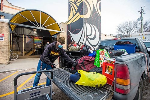 MIKAELA MACKENZIE / WINNIPEG FREE PRESS

Lolo Hillier, RaY employment training program member (left), and Shannon St. Clair unpack a pickup truck full of winter gear donations (from a memorial held last weekend for St. Clair's daughter) at RaY in Winnipeg on Friday, Nov. 26, 2021. For Kevin story.
Winnipeg Free Press 2021.