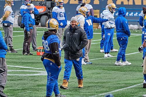 MIKE DEAL / WINNIPEG FREE PRESS
Winnipeg Blue Bombers Andrew Harris in winter parka and boots during practice at IG Field Friday morning.
211126 - Friday, November 26, 2021.