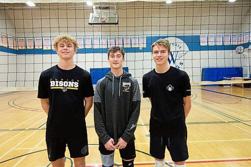 Mike Sudoma / Winnipeg Free Press
(Left to right) Dylan Martens, Rowan Krahn, and Sammy Ludwig of the Westgate Wings Varsity Boys volleyball team during practice Thursday night 
December 2, 2021