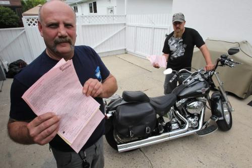 BORIS.MINKEVICH@FREEPRESS.MB.CA  100615 BORIS MINKEVICH / WINNIPEG FREE PRESS Dennis Poncik and Prem Juren pose with their tickets for loud motorcycle mufflers.