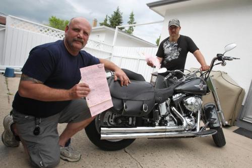 BORIS.MINKEVICH@FREEPRESS.MB.CA  100615 BORIS MINKEVICH / WINNIPEG FREE PRESS Dennis Poncik and Prem Juren pose with their tickets for loud motorcycle mufflers.