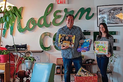 Canstar Community News Toy drive organizer Kyle Mason and Modern Coffee owner Allison Slessor check out the toy donations so far.