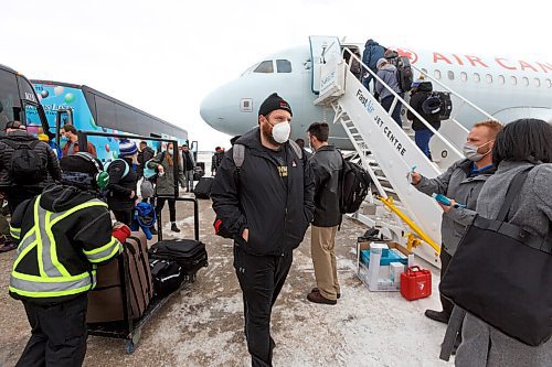 MIKE DEAL / WINNIPEG FREE PRESS
Winnipeg Blue Bombers Jake Thomas follows team mates as they board their plane to Hamilton for the 108th Grey Cup Tuesday afternoon.
211207 - Tuesday, December 07, 2021.