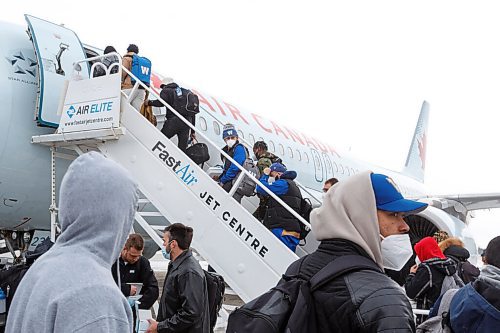 MIKE DEAL / WINNIPEG FREE PRESS
Winnipeg Blue Bombers board their plane to Hamilton for the 108th Grey Cup Tuesday afternoon.
211207 - Tuesday, December 07, 2021.