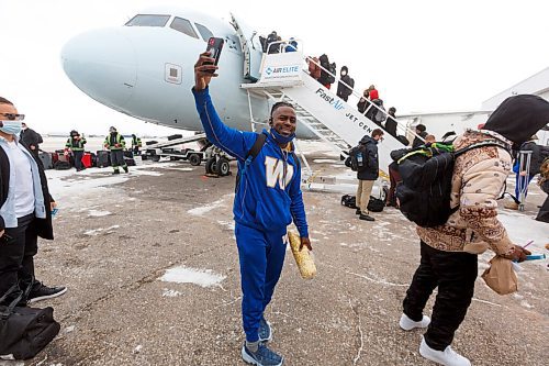 MIKE DEAL / WINNIPEG FREE PRESS
Winnipeg Blue Bombers Nick Taylor records the boarding their plane to Hamilton for the 108th Grey Cup Tuesday afternoon.
211207 - Tuesday, December 07, 2021.