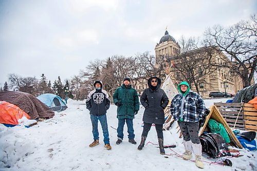 MIKAELA MACKENZIE / WINNIPEG FREE PRESS

John Butler (left), Willie Nicholas, Aaliyah Leach, and Tyler Dodge pose for a photo at the encampment on the legislative grounds in Winnipeg on Tuesday, Dec. 7, 2021. For Malak story.
Winnipeg Free Press 2021.