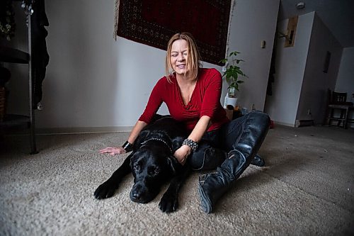 Daniel Crump / Winnipeg Free Press. Veronika Kanya and her guide dog Apache photographed in the living room of Kanyas home. Veronika became blind at age 25 and teaches jujitsu as a self defence instructor. December 8, 2021.