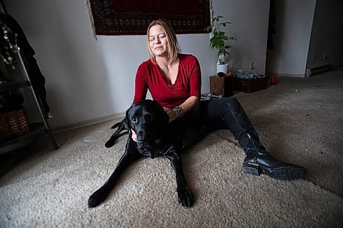 Daniel Crump / Winnipeg Free Press. Veronika Kanya and her guide dog Apache photographed in the living room of Kanyas home. Veronika became blind at age 25 and teaches jujitsu as a self defence instructor. December 8, 2021.