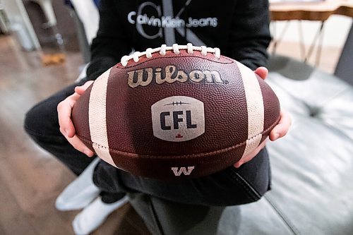 Daniel Crump / Winnipeg Free Press. AJ Boyko holds the ball that nearly hit him on Saturday during the CFL west division when a Saskatchewan Roughriders player allegedly threw the ball into the crowd in an attempt to hit a heckling fan. December 8, 2021.