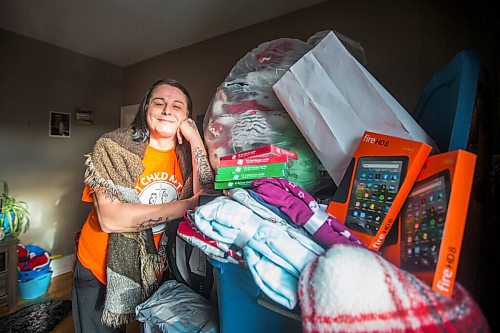 MIKAELA MACKENZIE / WINNIPEG FREE PRESS

Alaya McIvor poses for a portrait with Christmas donations for residential school survivors in Winnipeg on Thursday, Dec. 9, 2021. For Tyler story.
Winnipeg Free Press 2021.