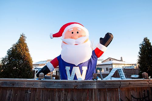 Daniel Crump / Winnipeg Free Press. A large inflatable  Santa dressed in a Winnipeg Blue Bombers jersey  can be seen near the intersection of Warde Avenue and Paddington Road in St. Vital, Winnipeg. The Santa is there every year, but this year he is dressed to cheer on the Bombers as they take on the Hamilton Tiger Cats in the Grey Cup on Sunday. December 10, 2021.