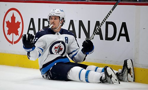Winnipeg Jets' Mark Scheifele (55) looks for a penalty call after being tripped up during second period NHL hockey action against the Vancouver Canucks' in Vancouver, BC, Friday, December 10, 2021. (TREVOR HAGAN / WINNIPEG FREE PRESS)
