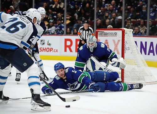 Winnipeg Jets' Blake Wheeler (26) holds the puck before trying to fire on Vancouver Canucks' goaltender Thatcher Demko (35) during second period NHL hockey action in Vancouver, BC, Friday, December 10, 2021. (TREVOR HAGAN / WINNIPEG FREE PRESS)