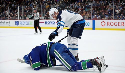 Winnipeg Jets' Andrew Copp (9) checks on Vancouver Canucks' Tyler Myers (57) after they collided during second period NHL hockey action against the Vancouver Canucks' in Vancouver, BC, Friday, December 10, 2021. (TREVOR HAGAN / WINNIPEG FREE PRESS)