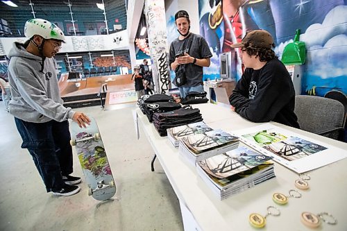 Daniel Crump / Winnipeg Free Press. Jackson Toone, creator of the Dont Waste Time skateboarding zine mans table at the launch for his zines fifth issue at The Edge Skatepark in downtown Winnipeg on Saturday. December 11, 2021.