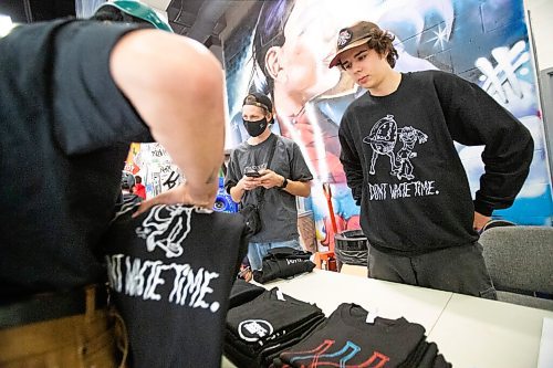 Daniel Crump / Winnipeg Free Press. Jackson Toone, creator of the Dont Waste Time skateboarding zine mans table at the launch for his zines fifth issue at The Edge Skatepark in downtown Winnipeg on Saturday. December 11, 2021.