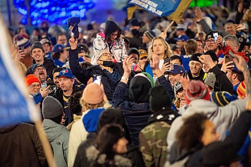 Mike Sudoma / Winnipeg Free Press
A Blue Bombers fan crowd surfs atop hundreds of fans at Portage and Main as they celebrate the Bombers 3rd consecutive year as Grey Cup Champions Sunday evening
December 12, 2021