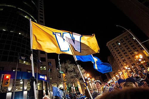 Mike Sudoma / Winnipeg Free Press
Blue and Gold Winnipeg Blue Bombers flags fly high as fans celebrate the Bombers overtime win over the Hamilton Tiger Cats at Portage and Main Sunday evening
December 12, 2021