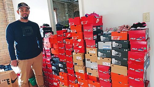 Canstar Community News Daniel Hidalgo of CommUNITY204 shows off some of the shoes his organization has collected to distribute to those who may need them this winter.