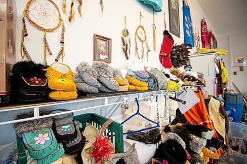 Mike Sudoma / Winnipeg Free Press
Handmade moccasins line a shelf in the Cree Ations shop with a baby photo of owner, Keith Proulx hung behind them
December 13, 2021