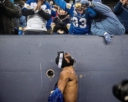 JESSICA LEE / WINNIPEG FREE PRESS

Fans pour beer in Bombers player Rasheed Baileys mouth during a celebration for the recent Grey Cup victory at IG Field on December 15, 2021.














