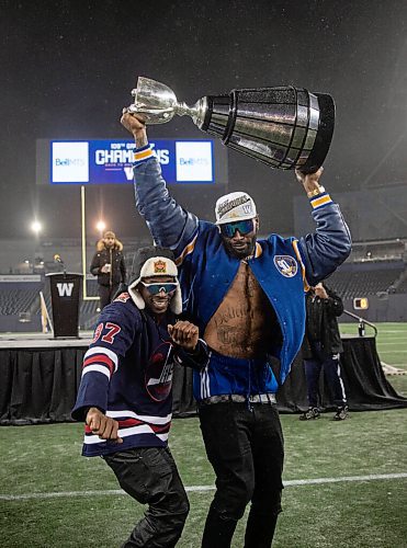 JESSICA LEE / WINNIPEG FREE PRESS

Bombers players Winston Rose (left) and Willie Jefferson celebrate the recent Grey Cup victory at IG Field on December 15, 2021.











