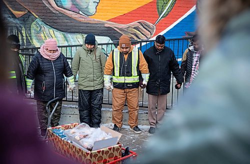 JESSICA LEE / WINNIPEG FREE PRESS

Elijah Woodhouse (in tan jacket), with his family and community members of Main Street Project, hold hands in a prayer after arriving to Main Street Project after a 231 km walk to raise awareness about addiction and homelessness on December 17, 2021. Woodhouse handed out snacks while walking and also gathered clothing and money donations for the Main Street Project.












