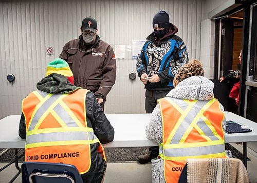 JESSICA LEE / WINNIPEG FREE PRESS

Darryl Bean (left) and Grayson Bean show their vaccination cards to the Covid Compliance team before being allowed entry into Selkirk Recreation Complex for a hockey game on December 17, 2021.













