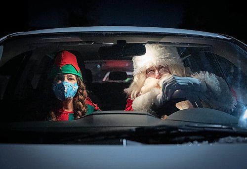 JESSICA LEE / WINNIPEG FREE PRESS

Alexis Johnson, who organizes bookings for Scheme a Dream, poses for a photo in Santas car with him on December 22, 2021.












