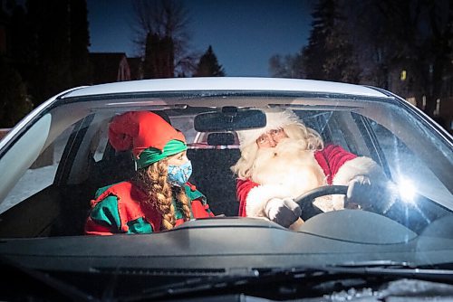JESSICA LEE / WINNIPEG FREE PRESS

Alexis Johnson, who organizes bookings for Scheme a Dream, poses for a photo in Santas car with him on December 22, 2021.










