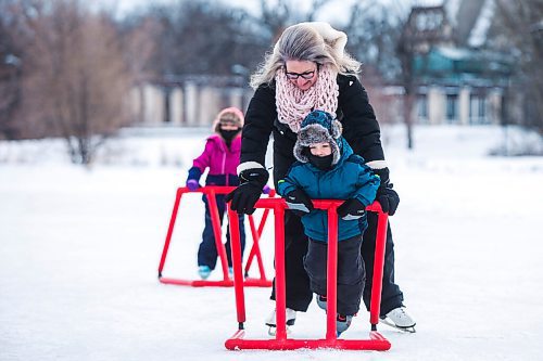 MIKAELA MACKENZIE / WINNIPEG FREE PRESS

Bennett Johnston, three, skates with his mom, mom, Laura Fletcher, for the very first time (on his brand new skates that he opened on Christmas morning) with his older sister, Olivia Johnston (four), behind at Assiniboine Park in Winnipeg on Saturday, Dec. 25, 2021.  Standup.
Winnipeg Free Press 2021.
