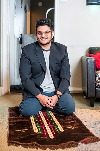 MIKAELA MACKENZIE / WINNIPEG FREE PRESS

Haseeb Ahmad poses for a portrait with a prayer mat, as he will be taking the new days off on Eid, in Winnipeg on Monday, Dec. 27, 2021.  For Bryce Hunt story.
Winnipeg Free Press 2021.