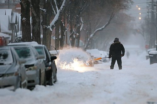 JOHN WOODS / WINNIPEG FREE PRESS
A person shovels out on McGee St as Winnipeggers make their way through a day of heavy snowfall on Monday, December 27, 2021. Twenty centimetres were expected to fall before the end of day.

Re: ?