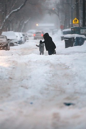 JOHN WOODS / WINNIPEG FREE PRESS
A mother and child make their way down McGee St as Winnipeggers get through a day of heavy snowfall on Monday, December 27, 2021. Twenty centimetres were expected to fall before the end of day.

Re: ?