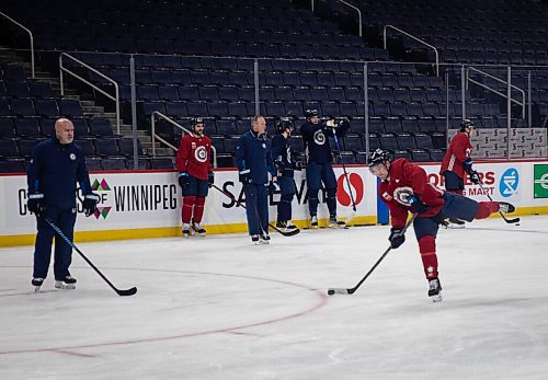 JESSICA LEE / WINNIPEG FREE PRESS

Neal Pionk (right), makes a slap shot during Jets practice on December 28, 2021 while his teammates look on.









