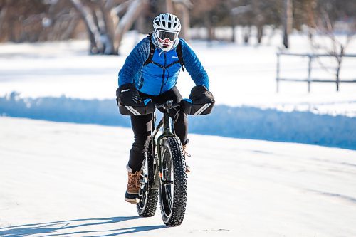 Daniel Crump / Winnipeg Free Press. A person rides a fat tire bike in Assiniboine Park in Winnipeg on New Years Day, braving temperatures around -40ºC with windchill. January 1, 2022.