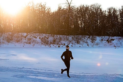 Daniel Crump / Winnipeg Free Press. A person runs on the frozen Assiniboine River in Winnipeg on New Years Day, braving temperatures around -40ºC with windchill. January 1, 2022.