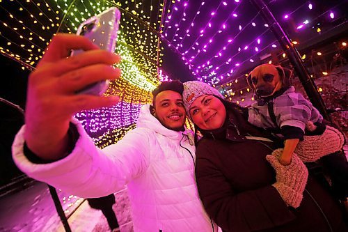 JOHN WOODS / WINNIPEG FREE PRESS
Ariane Bruyere and Khalil Ouertani snap a picture with their pup Chewy as they enjoy the light display by walking throughout The Forks, Monday, January 3, 2022. The young couple were celebrating their first wedding anniversary and Khalils recent arrival from Tunisia in Winnipeg. The couple met online and couldnt be together because of visa and COVID delays.

Re: Standup