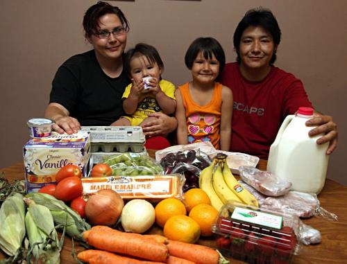 BORIS.MINKEVICH@FREEPRESS.MB.CA  100630 BORIS MINKEVICH / WINNIPEG FREE PRESS Jennifer Lajoie, Alias O'Cheek,1, Alexis O'Cheek,4, and Billy O'Cheek pose for a photo with some the food they get from the new Agape Table Grocery Cooperative.
