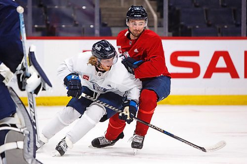 MIKE DEAL / WINNIPEG FREE PRESS
Winnipeg Jets' Kyle Connor (81) takes a sharp turn to get past Neal Pionk (4) during practice at Canada Life Centre Tuesday morning.
220111 - Tuesday, January 11, 2022.