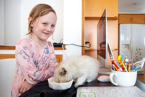 MIKE DEAL / WINNIPEG FREE PRESS
Piper Smith, 7, is a grade 2 student who is accessing the French Immersion program through MRLSC and has been doing remote school since September.
Piper takes part in her online class while her kitten, Renfri, sneaks a taste of her cream of mushroom soup.
The Manitoba Remote Learning Support Centre (MRLSC) launched one year ago, with a promise of providing families with at-home supports and real-time teaching for those who are immunocompromised.
See Maggie Macintosh story
220111 - Tuesday, January 11, 2022.