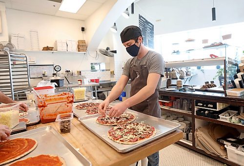 RUTH BONNEVILLE / WINNIPEG FREE PRESS

BIZ - Hildegards Bakery

Hildegards Bakery staff make pizzas next to their large stone oven Tuesday.
Supplement photo to use along with photo of David Newsom,co-owner of Hidegard's.  See Story.

At one point, all of Hildegards Bakerys online restaurant sales were coming through DoorDash, which dramatically decreases its revenue per sale. Newsom wants people to know the shop benefits more when orders come through Hildegards Bakerys website. 


Jan 11th,  2022
