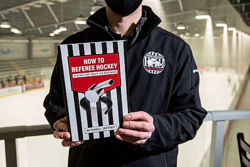 Mike Sudoma / Winnipeg Free Press
Hockey referee and author, Mitchell Jeffrey, shows off his book How to Referee Hockey at the MTS Iceplex Tuesday evening
January 11, 2022