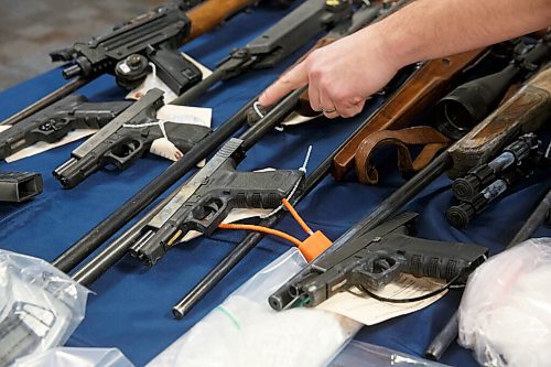 MIKE DEAL / WINNIPEG FREE PRESS
Several Glock handguns on display.
Winnipeg Police Inspector Elton Hall of the Organized Crime Unit speaks about Operation Phoenix during a press conference at Winnipeg Police Headquarters Thursday morning.
See Erik Pindera story
220113 - Thursday, January 13, 2022.