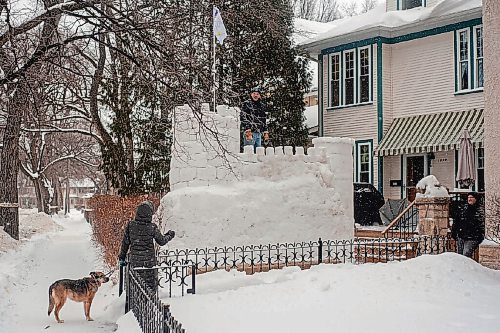 Canstar Community News Maurice "Mo" Barriault chats with his Wolseley Avenue neighbours atop the snow-castle slide he built in his yard.